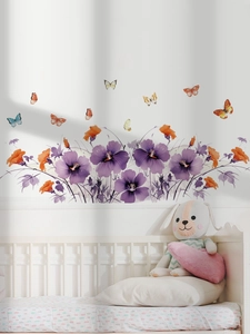 Floral wall stickers featuring purple hibiscus and colorful butterflies over a white nursery bed