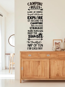 Detail of black PVC camping rules wall decal with forest peaks in a minimalist living room