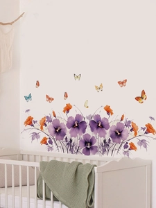 Close-up of floral wall stickers with purple and orange flowers in a nursery room