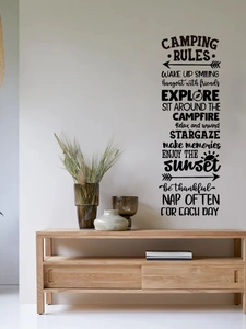 Detail of Camping Rules wall decal with forest icons on a white living room wall
