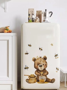 Close-up of watercolor honey bear wall stickers on a vintage kitchen refrigerator