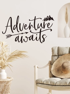 Black 'Adventure awaits' mountain wall decal displayed above a wooden chair in a room
