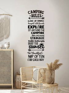 Detail of camping rules wall decal with mountains and forest design on a white wall