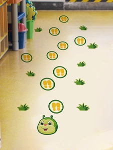 Detail of cartoon caterpillar floor stickers with green grass and footprints on yellow floor