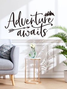 Adventure awaits wall decal with black mountain graphics in a modern living room setting