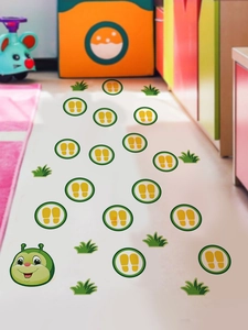 Detail of cartoon caterpillar floor stickers with green paw prints for kids room decor