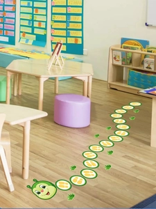 Detailed view of caterpillar floor stickers with colorful footprints on nursery wood floor