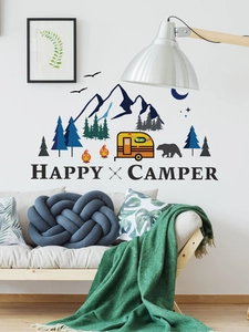 Detail of Happy Camper wall stickers with mountain, forest and yellow camper in a cozy living room