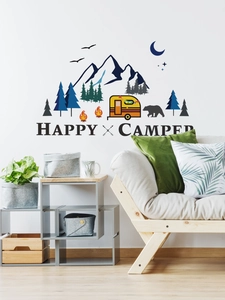 Detail showing Happy Camper wall decal with mountain, forest and van on a living room wall