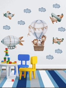 Detail of watercolor animal hot air balloon wall decals in a cozy nursery room setting