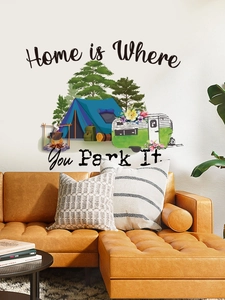 Close-up of camping wall decal with caravan and text Home is Where You Park It on a wall