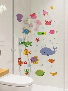 Detailed view of colorful ocean animal wall stickers applied to a glass shower door