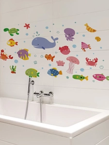 Detailed view of colorful cartoon sea life wall decals on a clean white bathroom tile