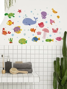 Detail view of waterproof ocean animal wall decals with whale and jellyfish on white tiles