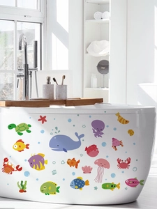Whale and sea turtle stickers applied on a bathtub in a modern bright bathroom