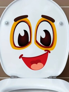 Close-up of a funny cartoon smiley face sticker applied on a white toilet lid