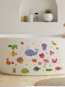 Detailed stickers showing cartoon whale, turtle, and jellyfish on a modern bathtub surface