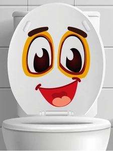 Close-up of a smiling cartoon face sticker applied to a white toilet lid in a bathroom