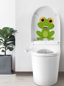 Detailed close-up of a cute green frog waterproof PVC sticker on a white toilet lid