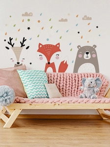 Close-up of cartoon fox, bear, and deer wall decals with stars in a nursery room