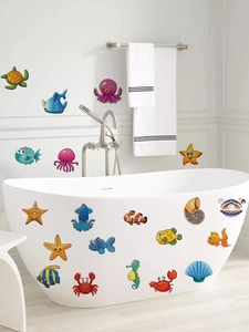 Close-up of waterproof cartoon ocean animal stickers on a white bathtub surface