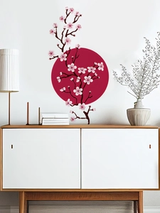Detailed view of cherry blossom wall stickers with red sun on modern living room wall