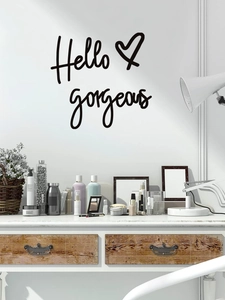Detailed view of Hello Gorgeous wall decal with heart on a white wall above a vanity