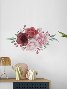 Détail d'un sticker mural rose et feuilles à l'aquarelle sur un mur blanc épuré