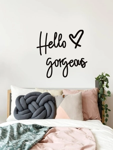 Modern vinyl wall decal with Hello Gorgeous script and heart detail in a bedroom