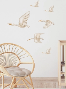 Detail of hand-painted flying swan wall stickers in beige tones for nursery decoration