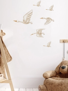 Detailed view of white swan wall stickers in a cozy Nordic style living room setting