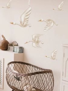 Detailed view of 6-piece cream flying swan wall stickers in a cozy nursery setting