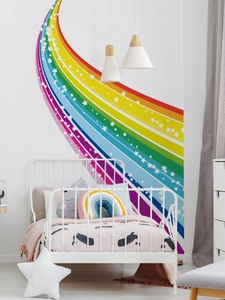 Detail of colorful rainbow and stars wall decal in a cozy children bedroom decor
