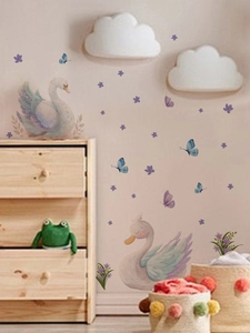 Detail view of cute swan and purple butterfly wall stickers in a cozy nursery bedroom