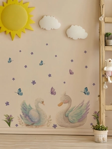 Detail of swan wall stickers with watercolor butterflies and flowers in a nursery setup