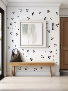 Black heart wall decals applied on a white hallway wall for modern home decoration