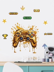Macro detail of golden gaming controller wall decal with pixel art icons and menu buttons