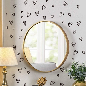 Artistic black hand-drawn heart wall stickers for modern living room decor on white wall