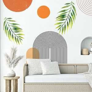 Detail of boho sun and palm leaf wall stickers in a modern minimalist living room