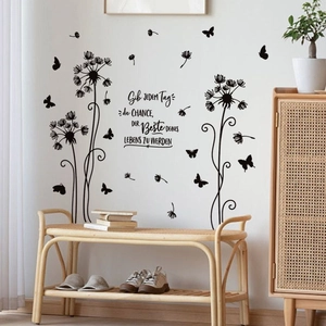 Detail of black dandelion wall decal with butterflies and German inspirational text