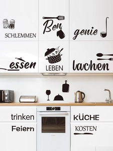 Detail of black vinyl kitchen wall decals with German text and cookware silhouettes