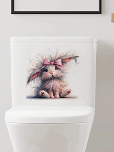 Close-up of fluffy Easter bunny toilet sticker with pink bow on white bathroom tank