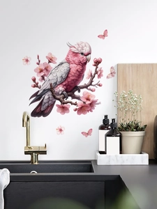 Detail of pink cockatoo and cherry blossoms self-adhesive PVC wall sticker on white wall