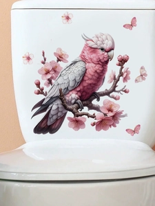 Detail view of pink cockatoo and cherry blossom adhesive stickers on a toilet tank