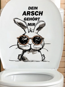 Detail of toilet lid sticker with a cartoon rabbit and funny German humorous text