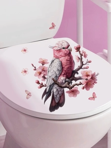 Detail of pink parrot and cherry blossom PVC self-adhesive sticker on white toilet lid
