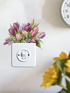 Close-up of vibrant tulip wall sticker applied around a light switch on a white wall