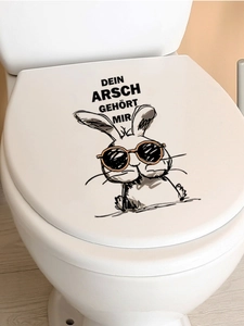 Close-up of PVC toilet sticker featuring a cartoon rabbit and funny German text