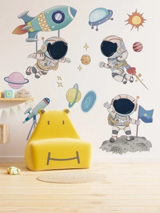 Detailed close-up of cartoon astronaut and rocket wall decals in a kid's bedroom setting