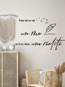 Detail of French quote wall decal with feathers and birds on a minimalist bedroom wall